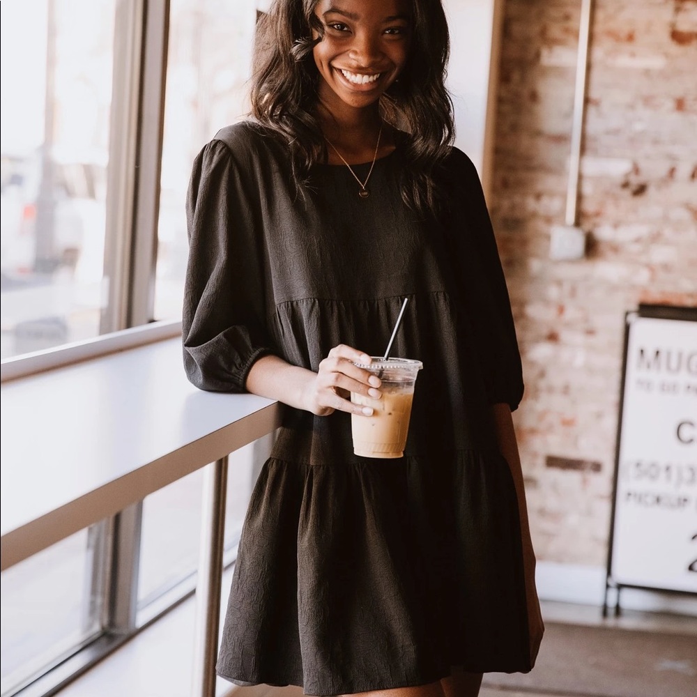 Voluminous, black floral dress.
